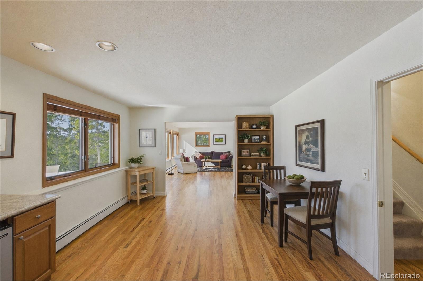 10798 Crystal Way Morrison, CO 80465 - Photo 23 of 36 a living room with furniture and a wooden floor