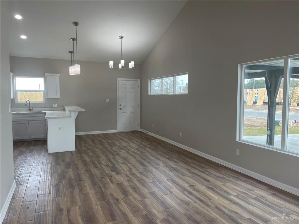 605 Sparrow Road Weslaco, TX 78596 - Photo 17 of 31 an empty room with wooden floor and windows