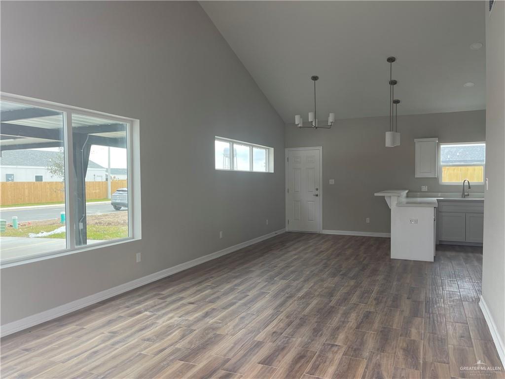 605 Sparrow Road Weslaco, TX 78596 - Photo 18 of 31 a view of an empty room with a window and wooden floor