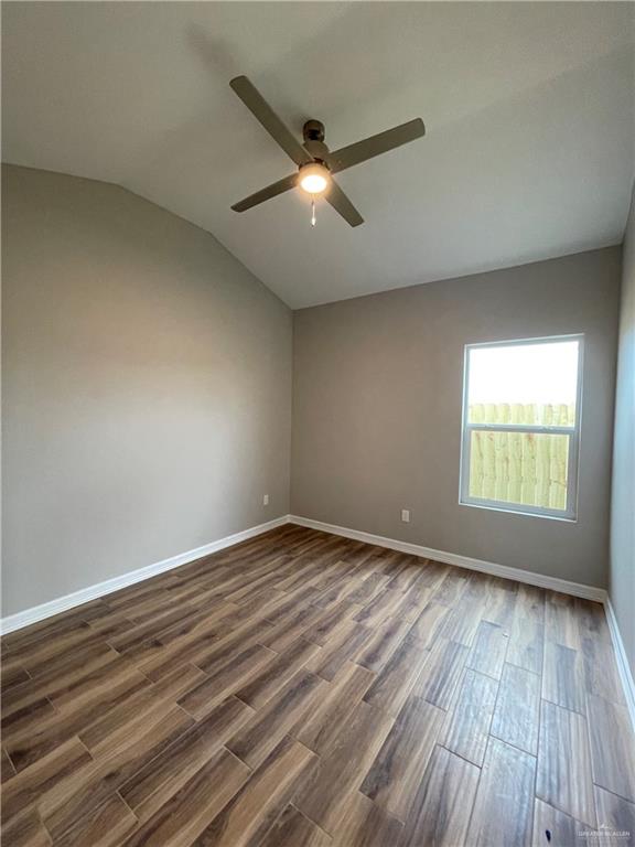 605 Sparrow Road Weslaco, TX 78596 - Photo 22 of 31 an empty room with wooden floor and windows