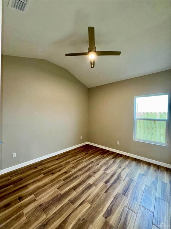 605 Sparrow Road Weslaco, TX 78596 - Photo 27 of 31 an empty room with wooden floor and windows