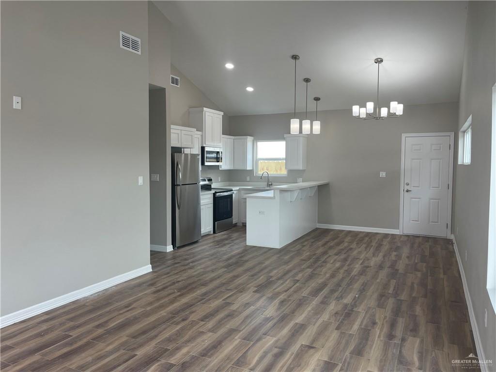 605 Sparrow Road Weslaco, TX 78596 - Photo 10 of 31 a view of a kitchen with a sink a refrigerator and window