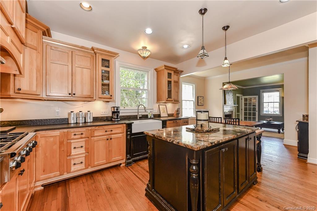 621 Westbury Road Charlotte, NC 28211 - Photo 11 of 45 a kitchen with granite countertop a sink stove and cabinets