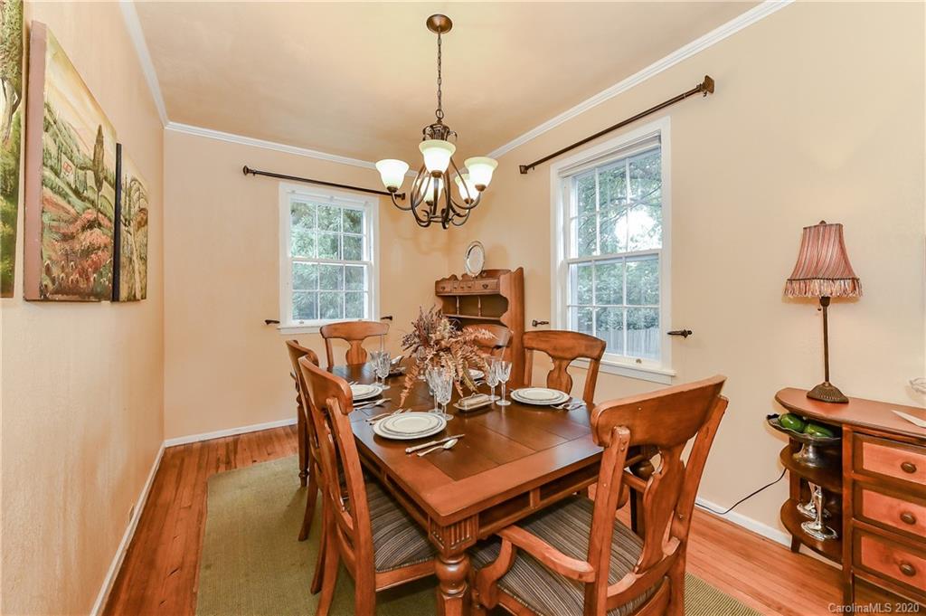 621 Westbury Road Charlotte, NC 28211 - Photo 16 of 45 a dining room with furniture a chandelier and wooden floor