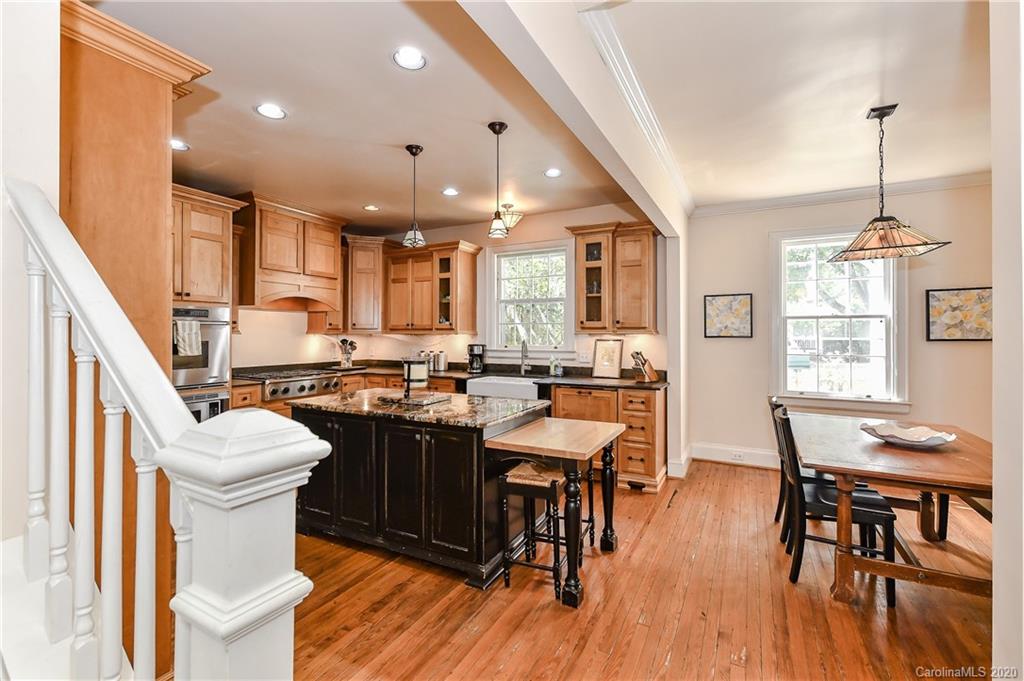 621 Westbury Road Charlotte, NC 28211 - Photo 21 of 45 a kitchen with a table chairs stove and cabinets