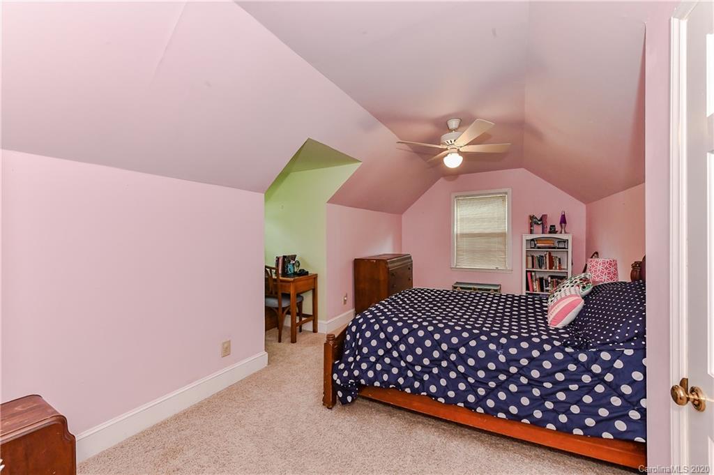 621 Westbury Road Charlotte, NC 28211 - Photo 29 of 45 a bedroom with a bed and dresser with mirror