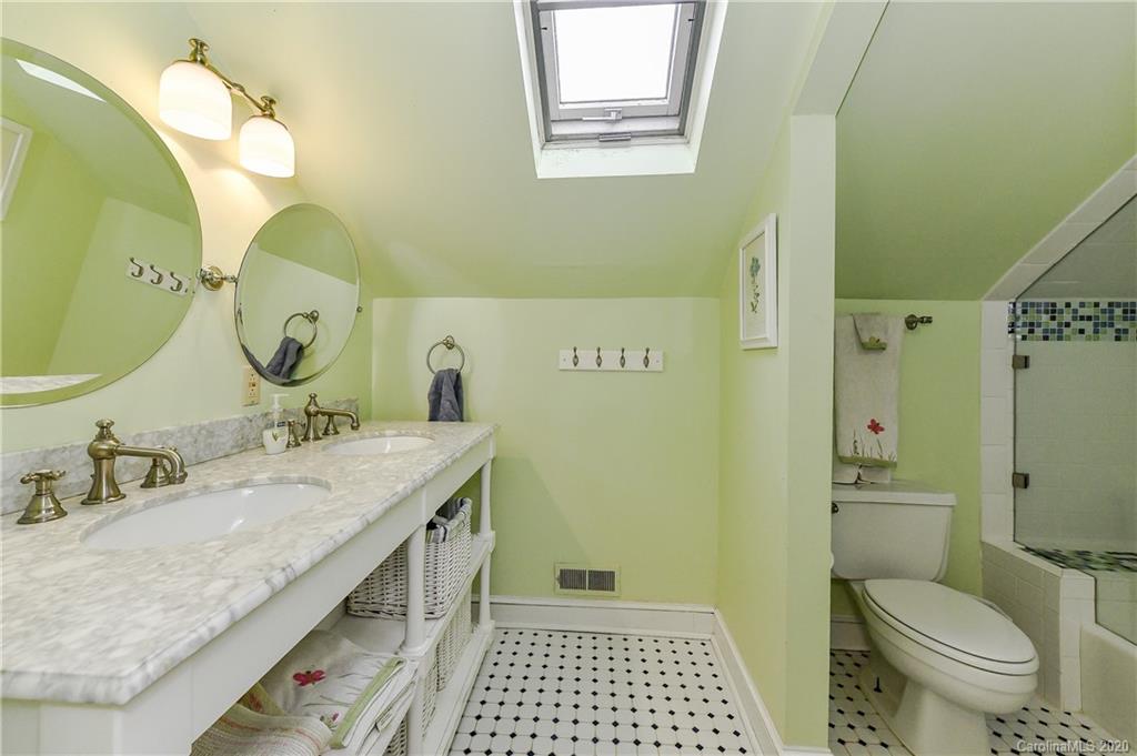 621 Westbury Road Charlotte, NC 28211 - Photo 30 of 45 a bathroom with a granite countertop sink mirror vanity and toilet
