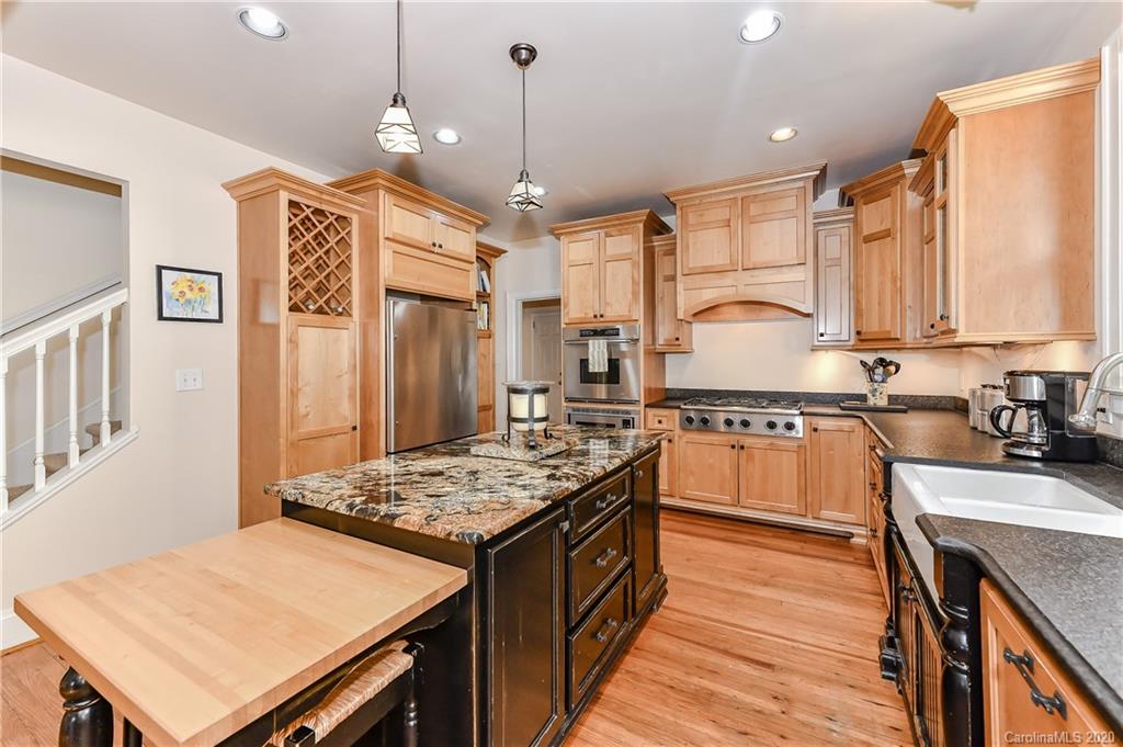 621 Westbury Road Charlotte, NC 28211 - Photo 9 of 45 a kitchen with a stove a sink dishwasher a kitchen island with wooden cabinets and floor