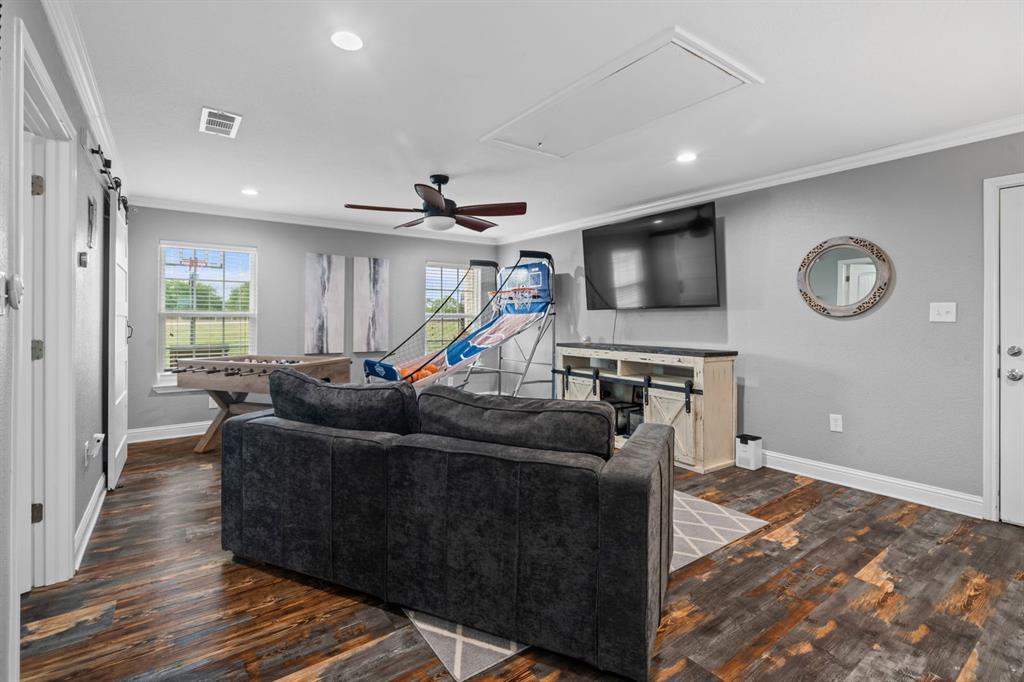 175 Porter Road Bartonville, TX 76226 - Photo 32 of 40 a living room with furniture and a wooden floor