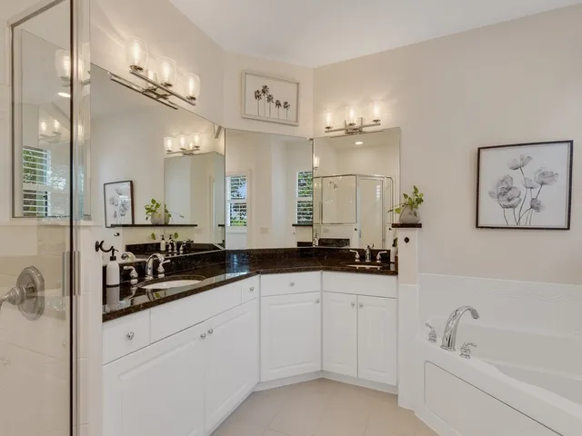 a bathroom with a sink a large mirror and a bathtub