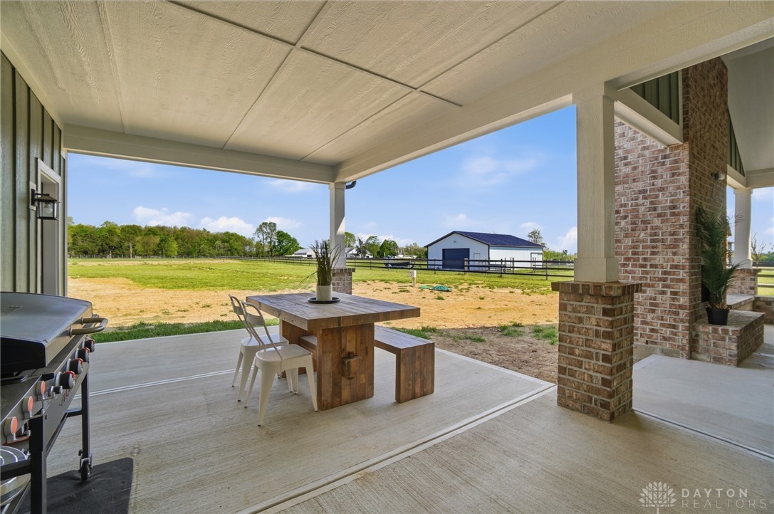 9364 Kenrick Road Dayton, OH 45458 - Photo 51 of 62 Enjoy idyllic views from this spacious covered patio, perfect for outdoor entertaining.
