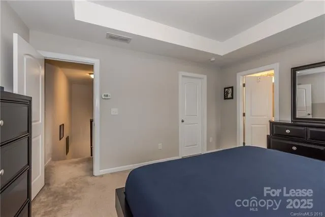 a bedroom with a bed and a dresser in it