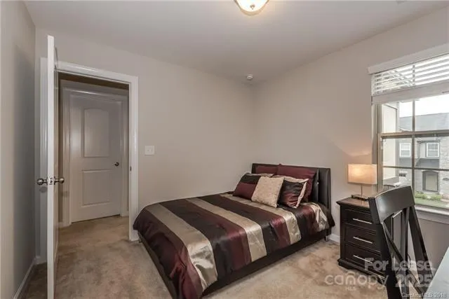 a bedroom with a bed chair and window