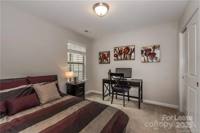 a view of a livingroom with workspace and a window