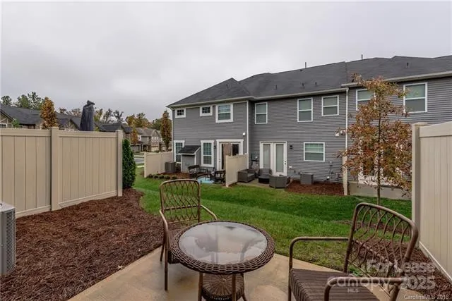 a view of a house with backyard sitting area and garden
