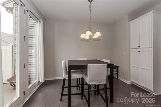 a view of a dining room with furniture wooden floor and a chandelier