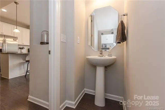 a bathroom with a sink a mirror and a window