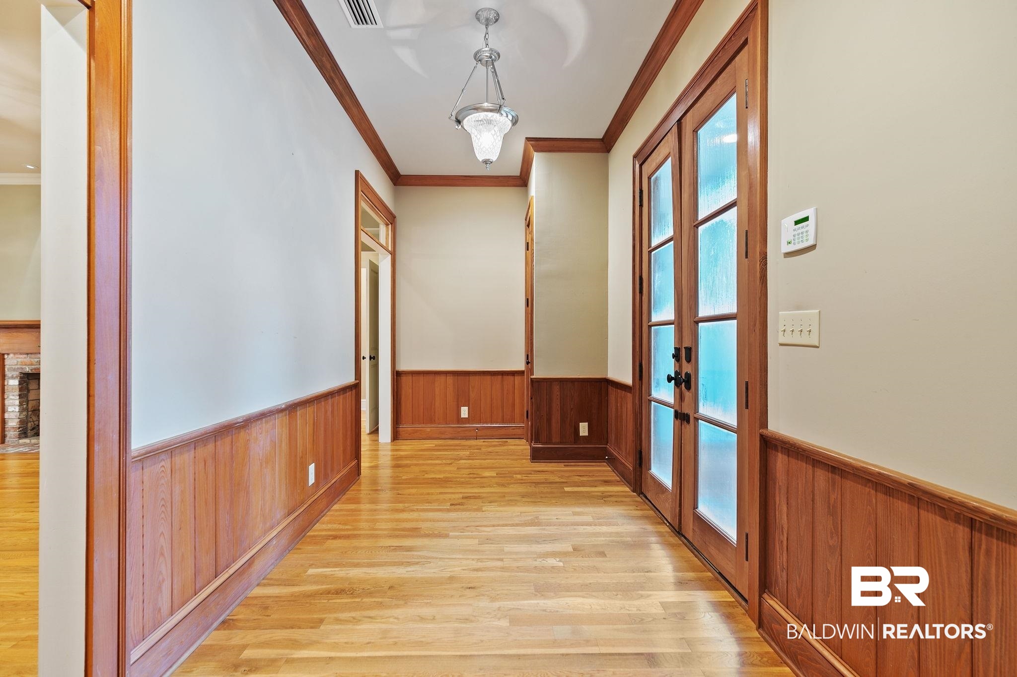 202 Beall Lane Daphne, AL 36526 - Photo 5 of 46 Corridor featuring french doors, ornamental molding, light wood-type flooring, and plenty of natural light