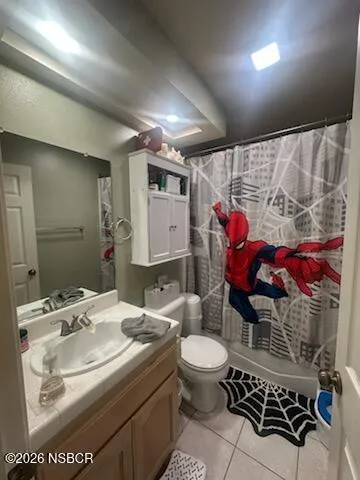 a bed sitting in a bedroom next to a lamp