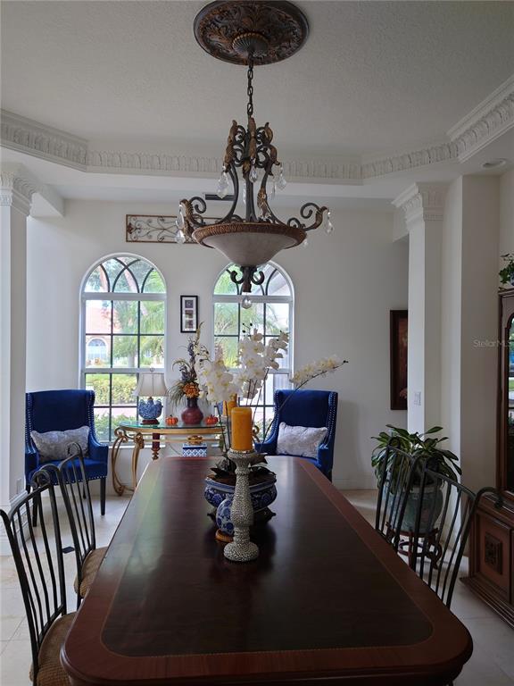 10628 Pontofino Circle Trinity, FL 34655 - Photo 12 of 75 a view of a dining room with furniture wooden floor and chandelier