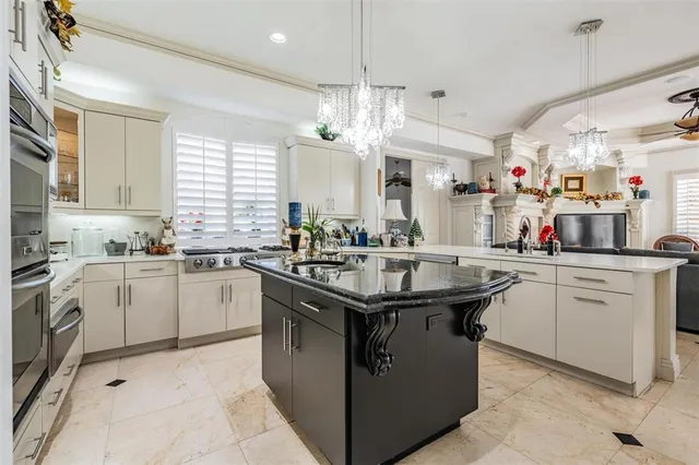 a bedroom with bed and a chandelier