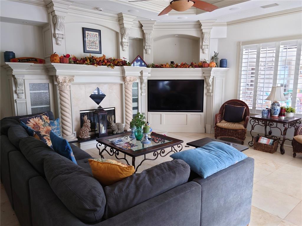 10628 Pontofino Circle Trinity, FL 34655 - Photo 21 of 75 a living room with furniture a flat screen tv and a fireplace