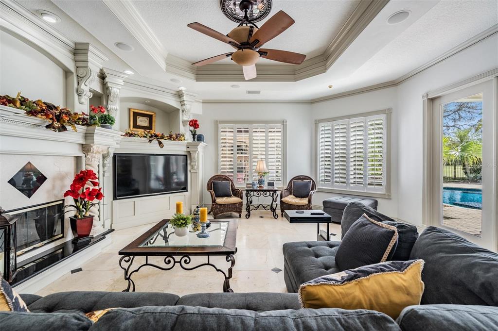 10628 Pontofino Circle Trinity, FL 34655 - Photo 23 of 75 a living room with furniture fireplace and a large window