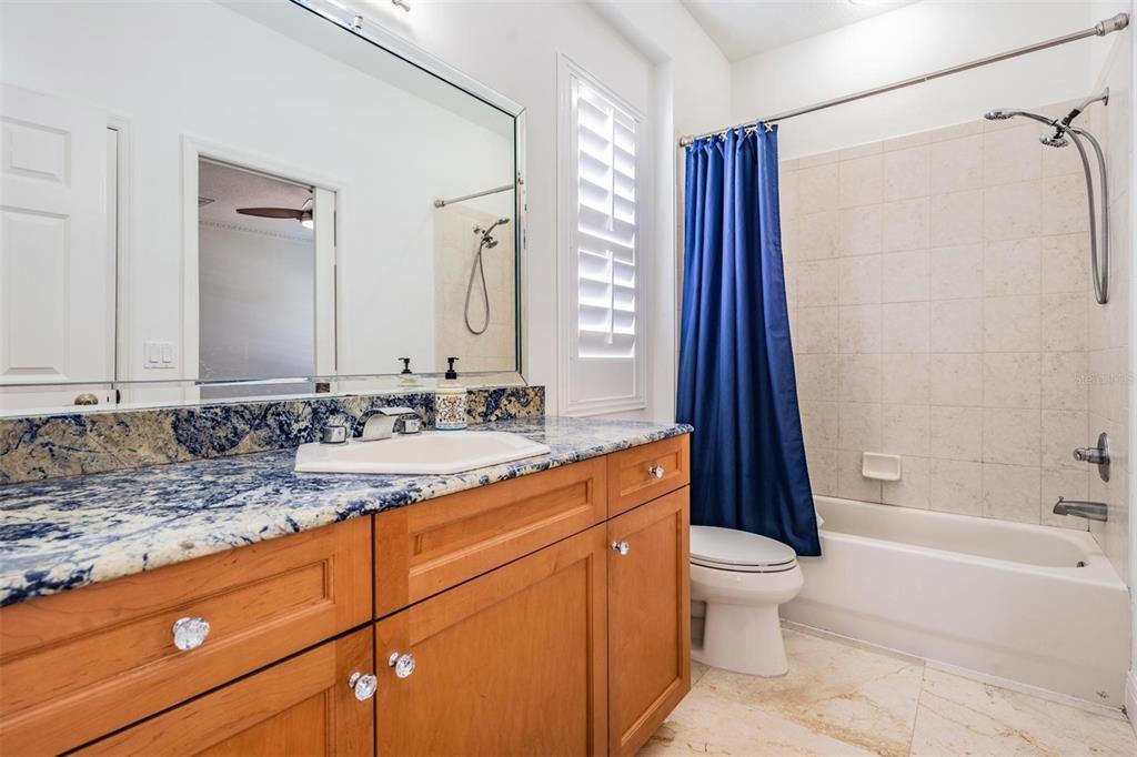 10628 Pontofino Circle Trinity, FL 34655 - Photo 35 of 75 a bathroom with a granite countertop sink toilet and shower