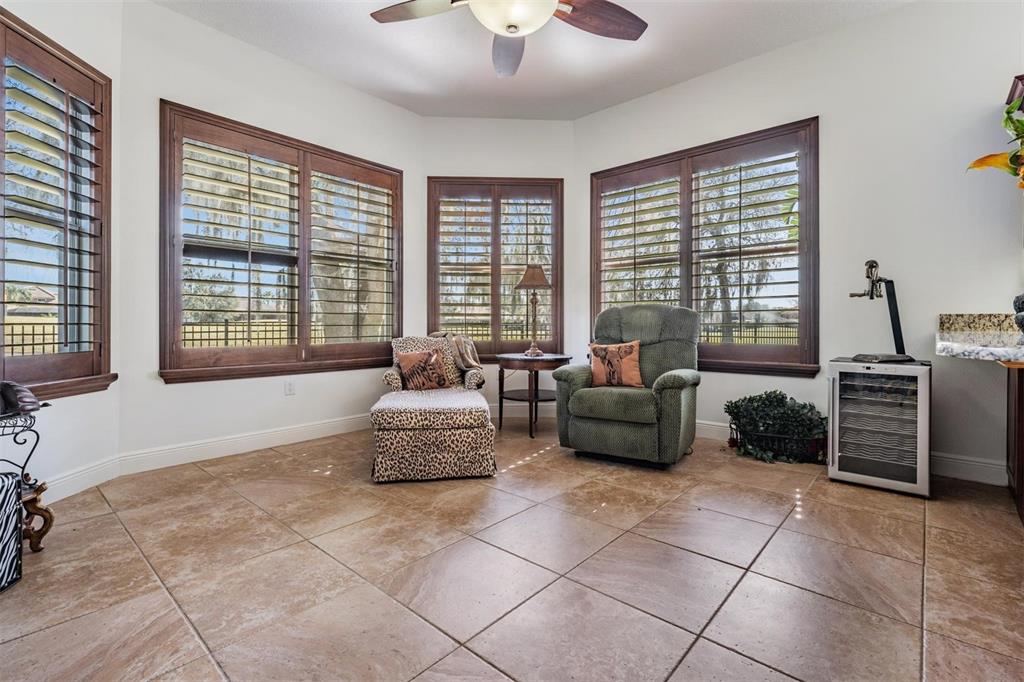 10628 Pontofino Circle Trinity, FL 34655 - Photo 57 of 75 a living room with furniture and a floor to ceiling window