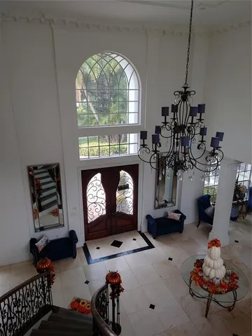 a view of a dining room with furniture wooden floor and chandelier