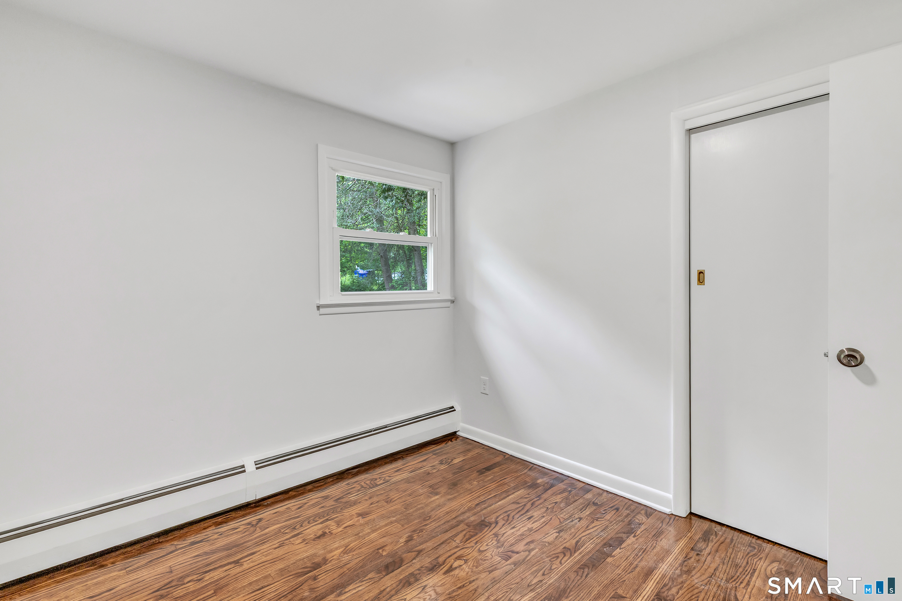 7 Longview Road Newtown, CT 06482 - Photo 22 of 40 an empty room with wooden floor and windows