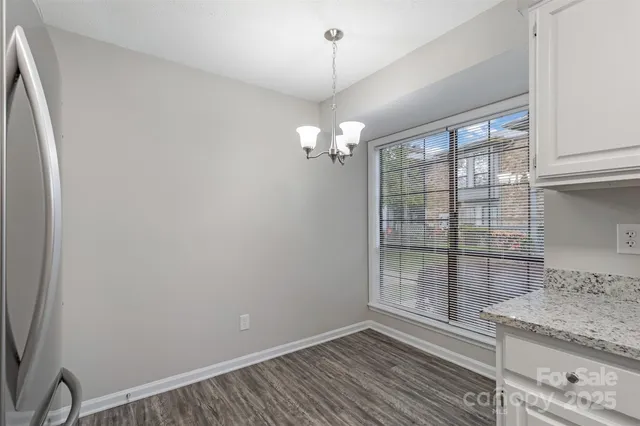 a view of a room with wooden floor and windows