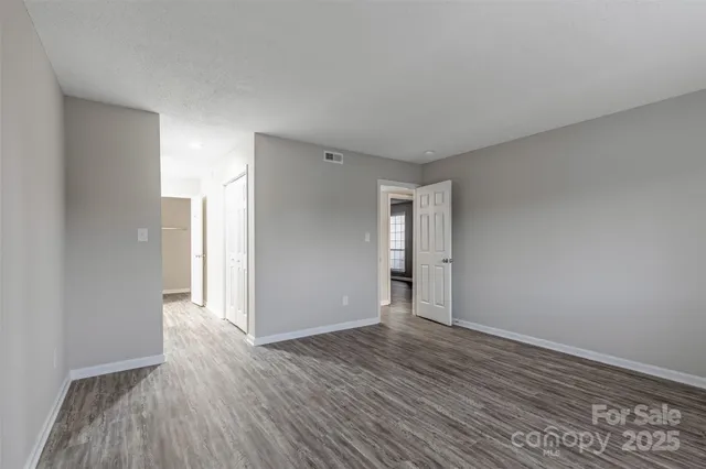 a view of an empty room and wooden floor