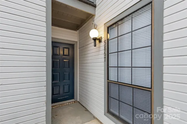 a view of a door and a window of the house
