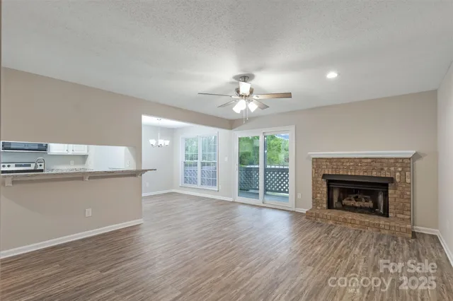 wooden floor fireplace and natural light in room