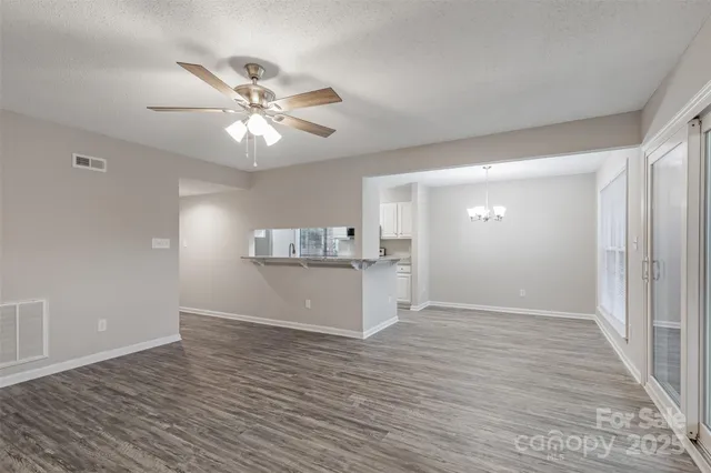 a view of a kitchen with a sink and a refrigerator