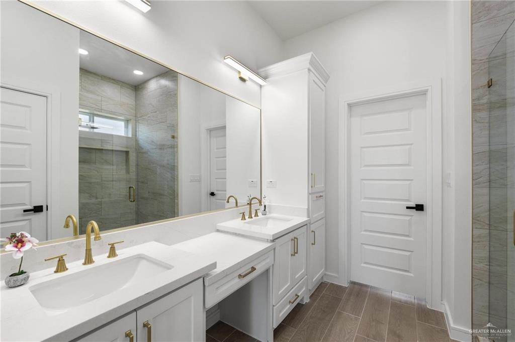 505 Freedom Way Weslaco, TX 78596 - Photo 9 of 20 a bathroom with a double vanity sink a mirror and a shower