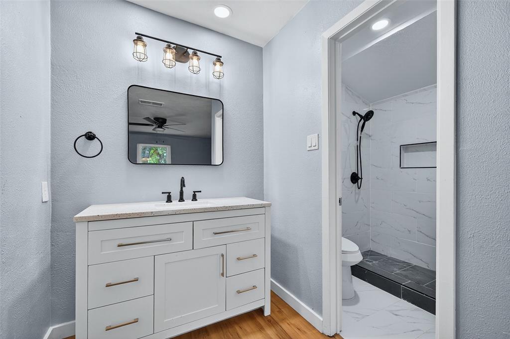 1401 La Salle Drive Sherman, TX 75090 - Photo 13 of 24 a bathroom with a sink a mirror and a shower