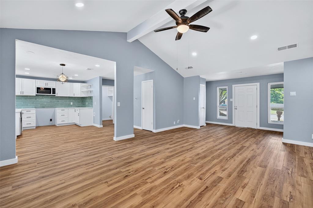 1401 La Salle Drive Sherman, TX 75090 - Photo 5 of 24 a view of an empty room and kitchen view with wooden floor