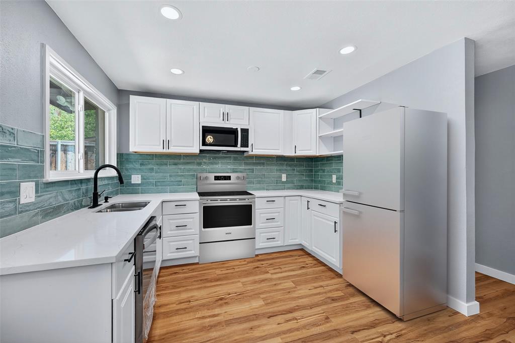 1401 La Salle Drive Sherman, TX 75090 - Photo 10 of 24 a kitchen with granite countertop a refrigerator stove top oven and sink