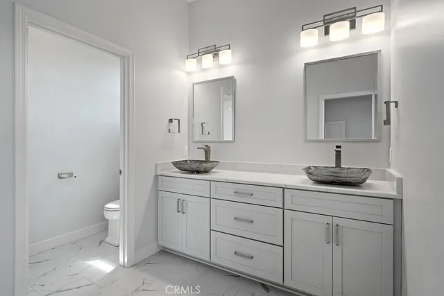 a view of an empty room with a window and a kitchen