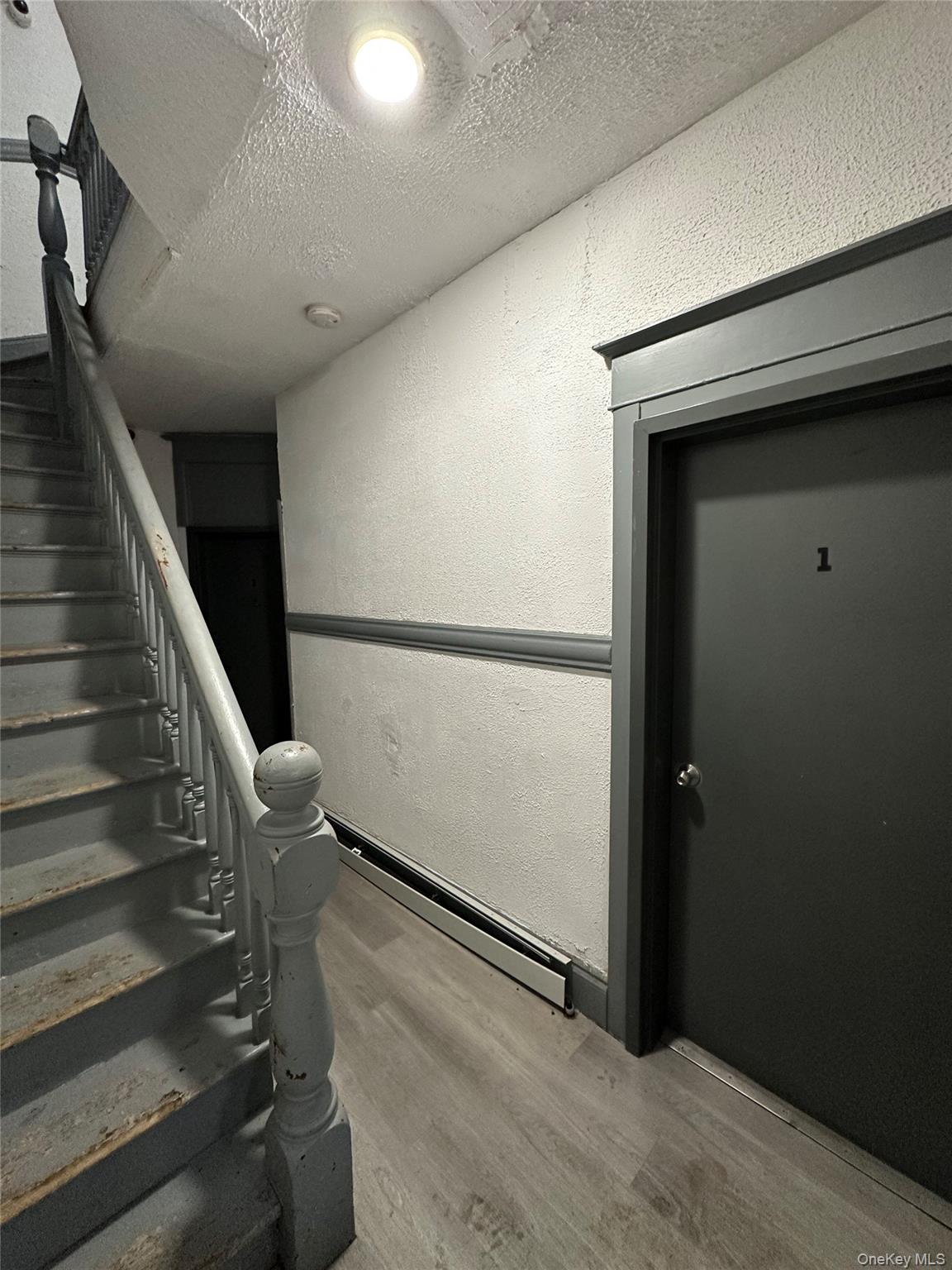 31 Victor Street Yonkers, NY 10701 - Photo 4 of 11 Stairway featuring a textured wall, wood finished floors, a textured ceiling, and recessed lighting