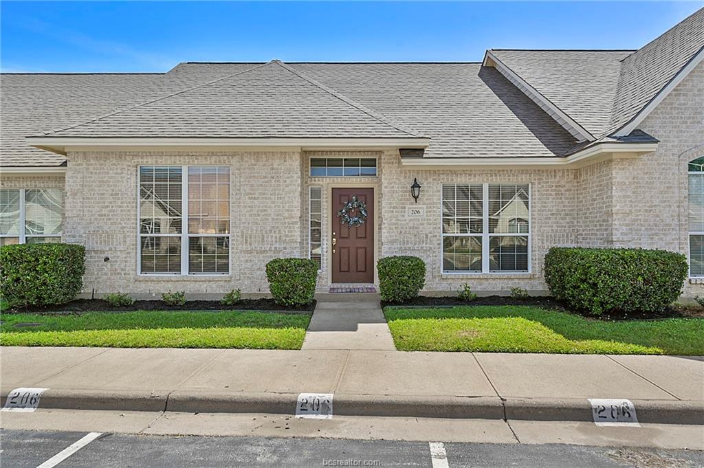 206 Fraternity Row College Station, TX 77845 - Photo 1 of 18 a front view of a brick house with a yard