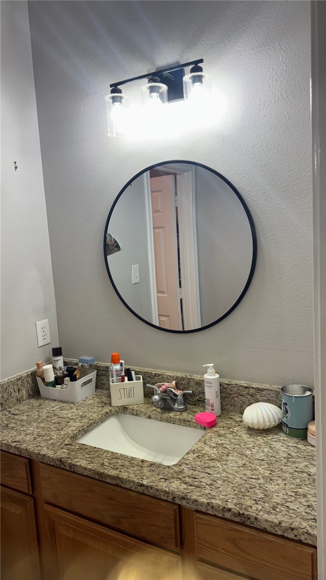 206 Fraternity Row College Station, TX 77845 - Photo 10 of 18 a bathroom with a granite countertop sink and a mirror