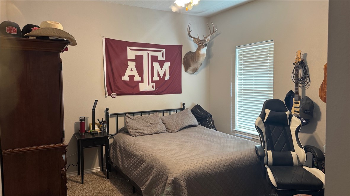 206 Fraternity Row College Station, TX 77845 - Photo 12 of 18 a bedroom with a bed and wooden floor