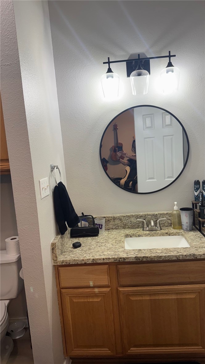 206 Fraternity Row College Station, TX 77845 - Photo 14 of 18 a bathroom with a granite countertop sink and a mirror