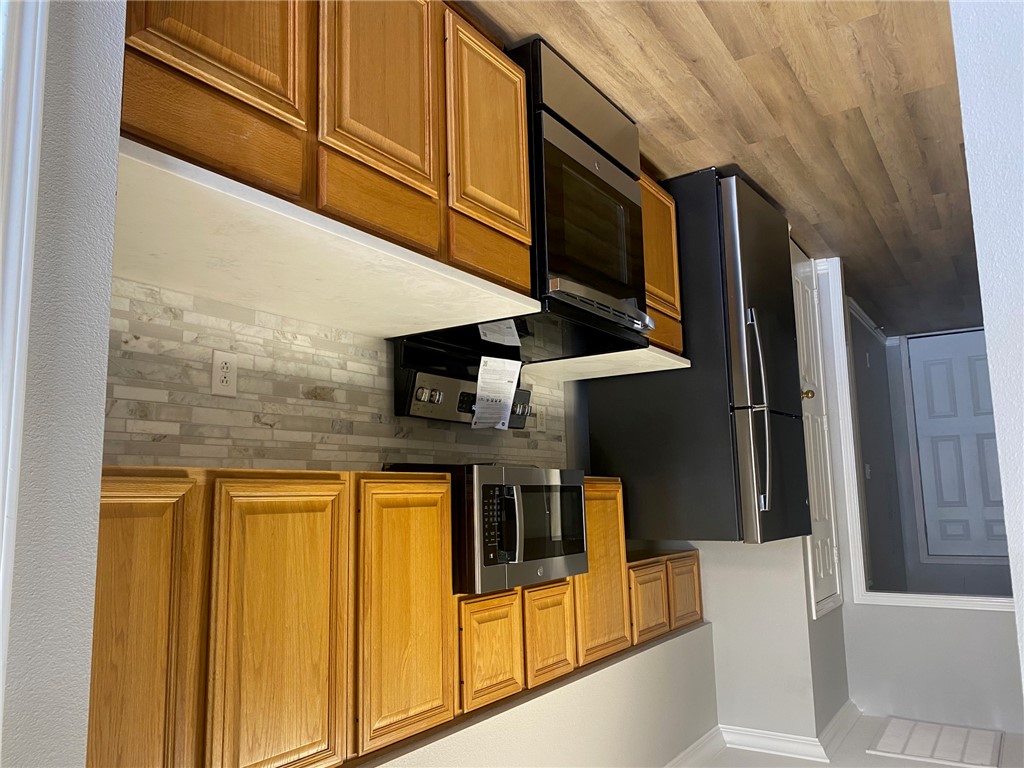 206 Fraternity Row College Station, TX 77845 - Photo 2 of 18 a kitchen with stainless steel appliances granite countertop a refrigerator stove and microwave