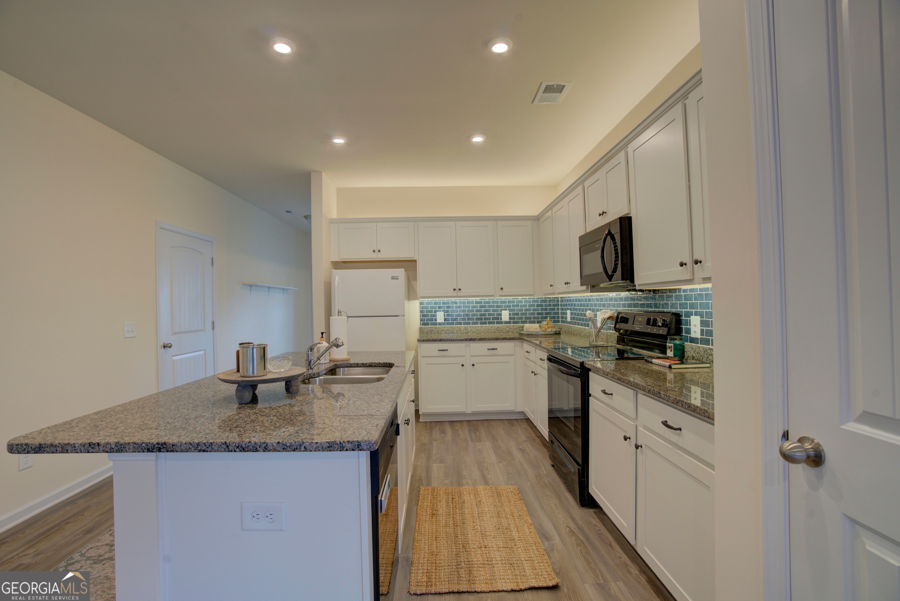 12 Applewood Drive Northeast Rome, GA 30165 - Photo 15 of 31 a kitchen with granite countertop a sink stove and cabinets