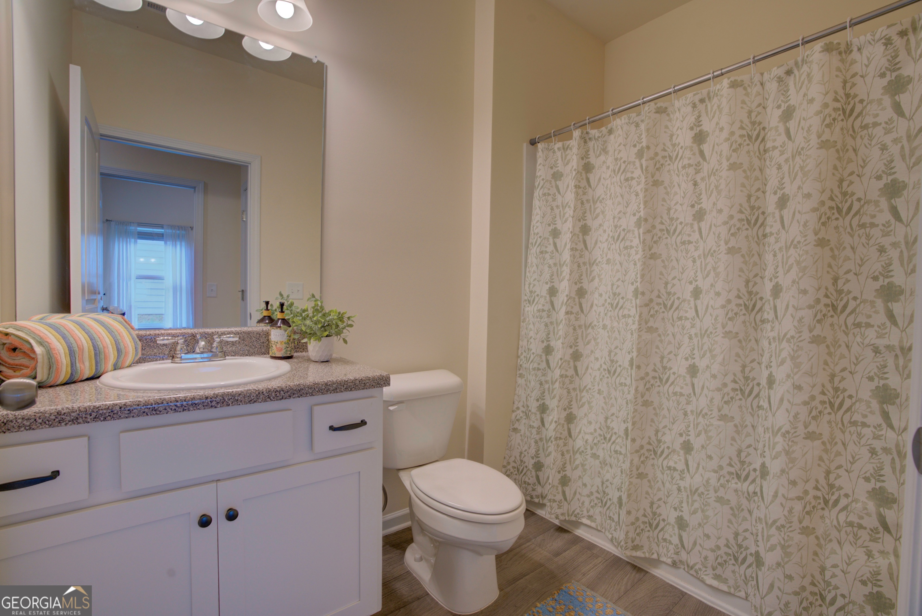 12 Applewood Drive Northeast Rome, GA 30165 - Photo 29 of 31 a bathroom with a granite countertop sink a toilet and a mirror