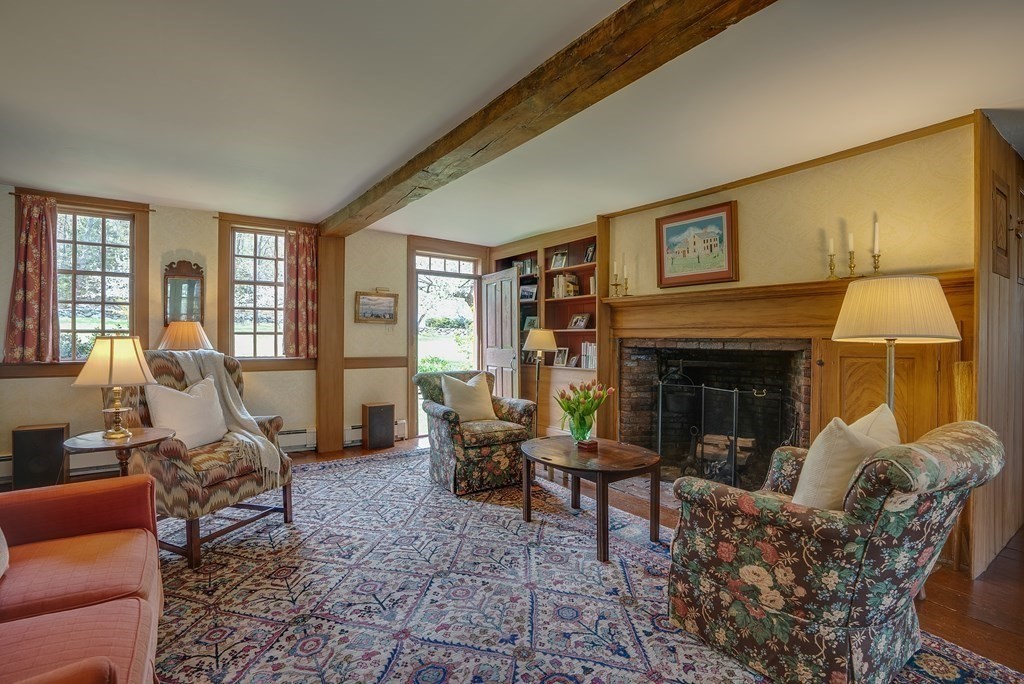 83 Whitney Road Harvard, MA 01451 - Photo 17 of 41 a living room with furniture a fireplace and a large window